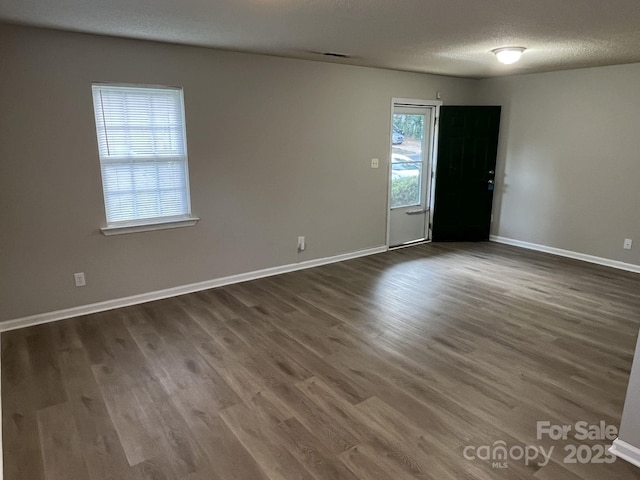 1714 Maribel Ave, Charlotte, NC 28216 - empty room with dark wood finished floors and a textured ceiling
