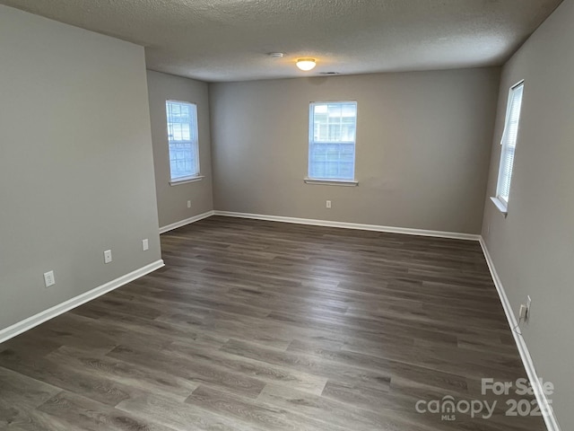 1714 Maribel Ave, Charlotte, NC 28216 - spare room with plenty of natural light, a textured ceiling, and dark wood-type flooring