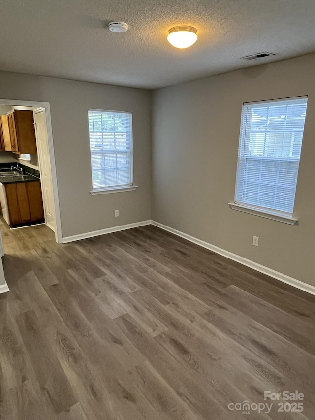 1714 Maribel Ave, Charlotte, NC 28216 - empty room with dark wood-style flooring, a smoke detector, and a textured ceiling