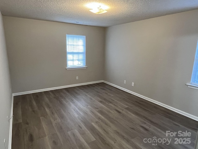 1714 Maribel Ave, Charlotte, NC 28216 - empty room with dark wood-style flooring and a textured ceiling
