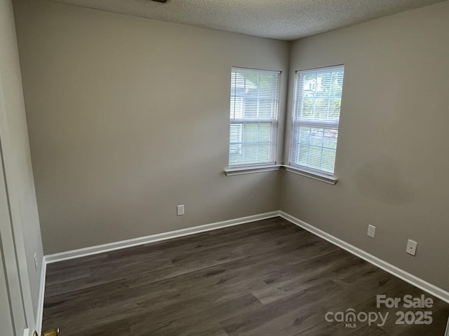 1714 Maribel Ave, Charlotte, NC 28216 - spare room with a textured ceiling and dark wood-style flooring