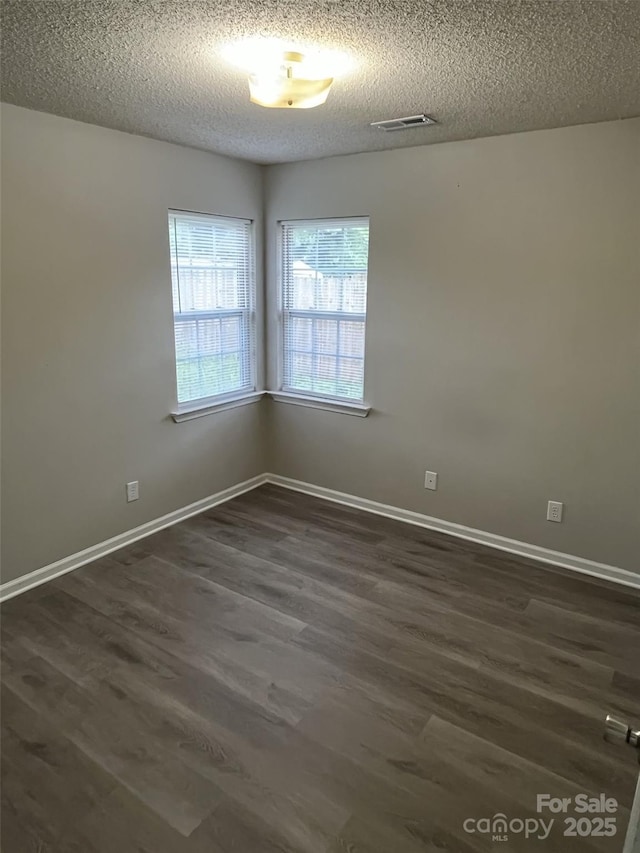 1714 Maribel Ave, Charlotte, NC 28216 - empty room featuring dark wood finished floors and a textured ceiling