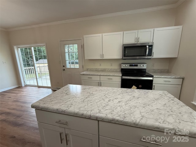 40287 Palmerville Rd, New London, NC 28127 - kitchen featuring stainless steel appliances, wood finished floors, crown molding, and white cabinetry