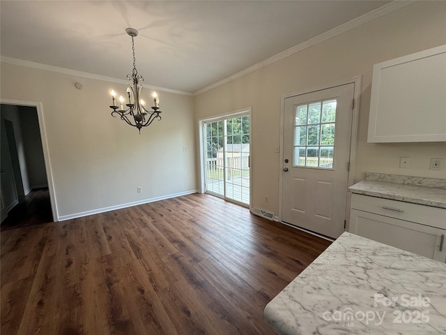 40287 Palmerville Rd, New London, NC 28127 - unfurnished dining area with dark wood finished floors, a chandelier, and ornamental molding