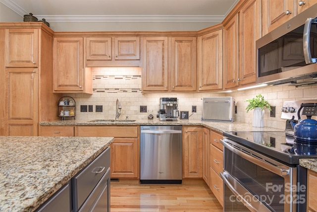 3 Chickadee Ln, Fairview, NC 28730 - kitchen with appliances with stainless steel finishes, ornamental molding, light wood finished floors, decorative backsplash, and light stone counters