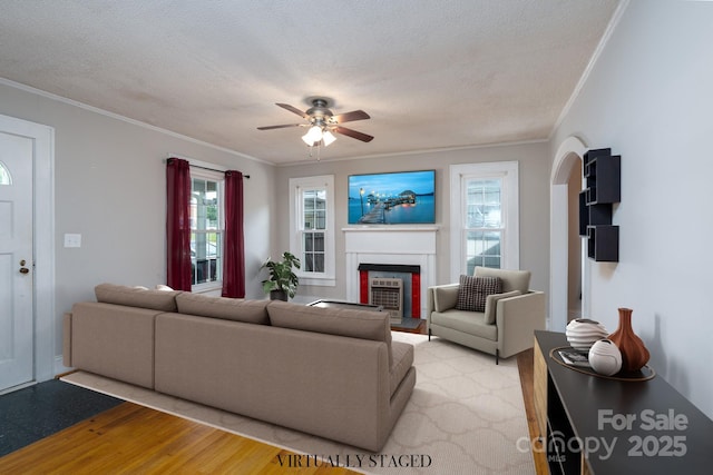 357 N Main St, Mount Pleasant, NC 28124 - living room with ornamental molding, a ceiling fan, a fireplace with flush hearth, light wood-style floors, and a textured ceiling