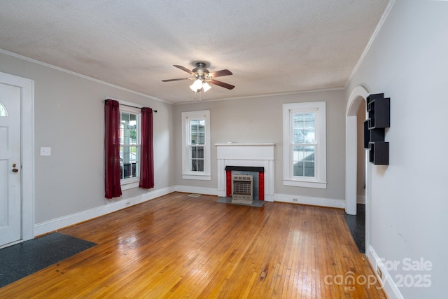 357 N Main St, Mount Pleasant, NC 28124 - unfurnished living room with hardwood / wood-style floors, ceiling fan, crown molding, a fireplace with flush hearth, and a textured ceiling