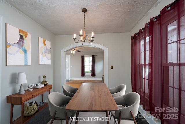 357 N Main St, Mount Pleasant, NC 28124 - dining room with a textured ceiling, a chandelier, arched walkways, crown molding, and a ceiling fan