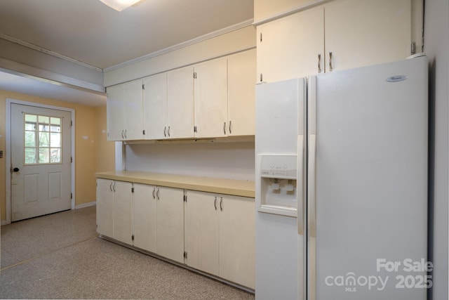 357 N Main St, Mount Pleasant, NC 28124 - kitchen featuring white fridge with ice dispenser, crown molding, light floors, and light countertops
