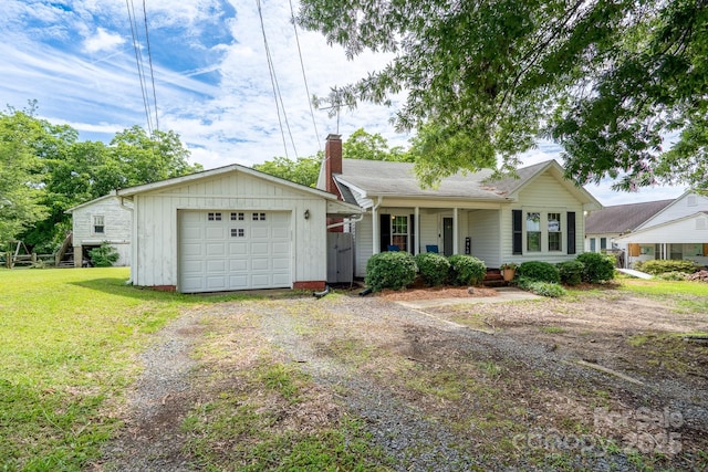 357 N Main St, Mount Pleasant, NC 28124 - single story home with a porch, driveway, a front lawn, a chimney, and an attached garage