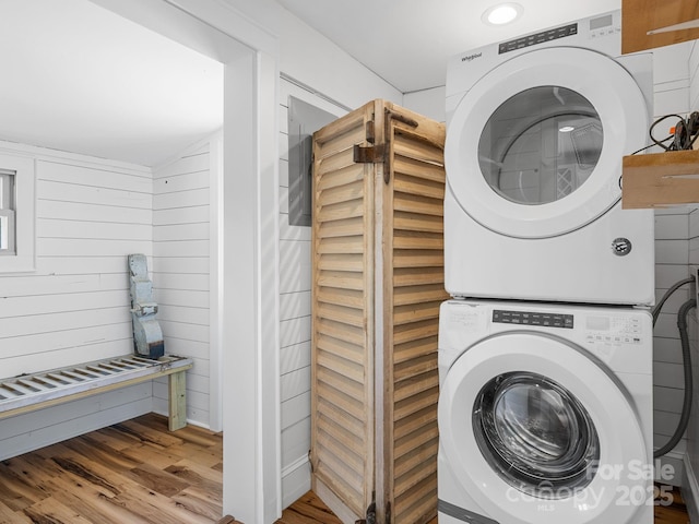 2784 Pea Ridge Rd, Mill Spring, NC 28756 - washroom with stacked washer and clothes dryer, wood finished floors, and wooden walls