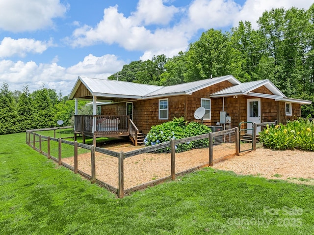 2784 Pea Ridge Rd, Mill Spring, NC 28756 - view of front of property featuring a metal roof, a wooden deck, and a garden
