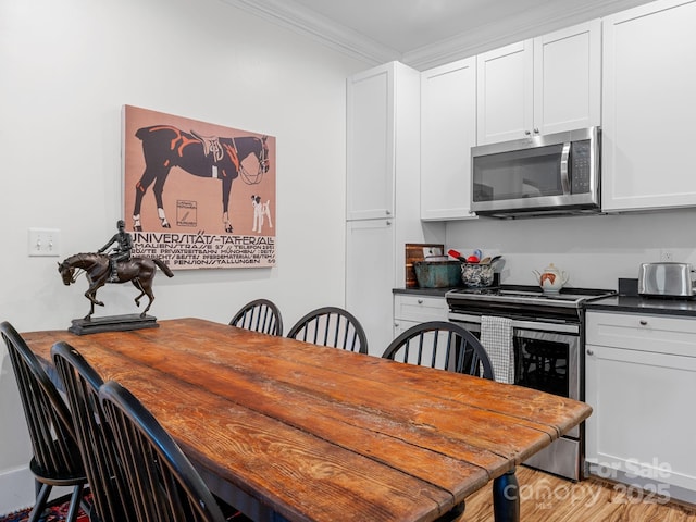 2784 Pea Ridge Rd, Mill Spring, NC 28756 - dining space with crown molding and light wood-style floors