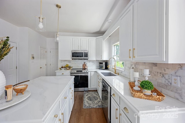 5005 Chestnut Knoll Ln, Charlotte, NC 28269 - kitchen featuring appliances with stainless steel finishes, dark wood finished floors, white cabinets, and decorative backsplash