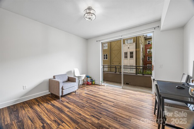 1315 E Blvd Unit 321, Charlotte, NC 28203 - living area featuring wood finished floors and an upstairs landing
