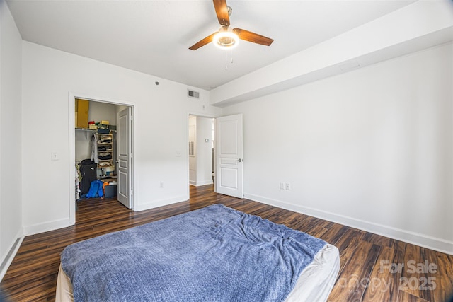 1315 E Blvd Unit 321, Charlotte, NC 28203 - bedroom with a spacious closet, dark wood finished floors, a closet, and ceiling fan