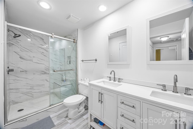 1315 E Blvd Unit 321, Charlotte, NC 28203 - full bathroom featuring a marble finish shower, double vanity, recessed lighting, and marble finish floors