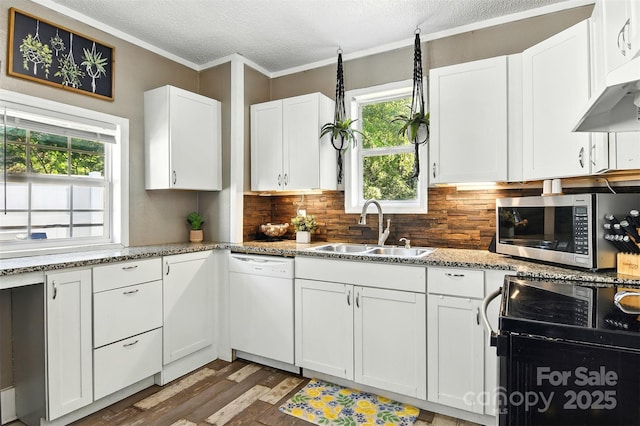 840 10th Street Blvd NW, Hickory, NC 28601 - kitchen featuring white dishwasher, stainless steel microwave, light wood-style floors, a textured ceiling, and backsplash