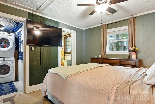 840 10th Street Blvd NW, Hickory, NC 28601 - bedroom with stacked washer and clothes dryer, a textured ceiling, and a ceiling fan