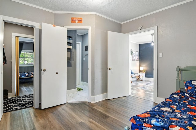 840 10th Street Blvd NW, Hickory, NC 28601 - bedroom with wood finished floors, crown molding, and a textured ceiling