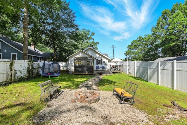 840 10th Street Blvd NW, Hickory, NC 28601 - fenced backyard featuring a trampoline, an outdoor fire pit, and a deck