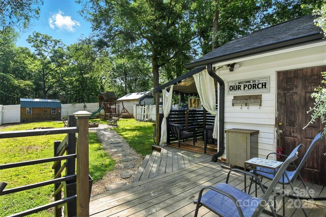 840 10th Street Blvd NW, Hickory, NC 28601 - wooden deck with a playground, a shed, and a fenced backyard