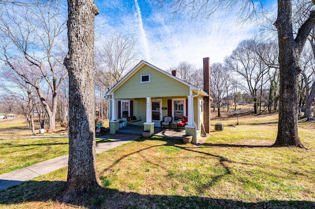 905 Orchard St SW, Valdese, NC 28690 - bungalow-style house featuring a chimney, a porch, and a front lawn