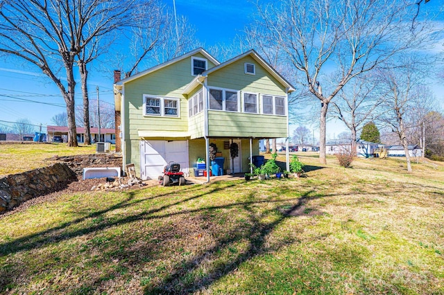 905 Orchard St SW, Valdese, NC 28690 - back of property with a garage, a sunroom, a chimney, and a yard