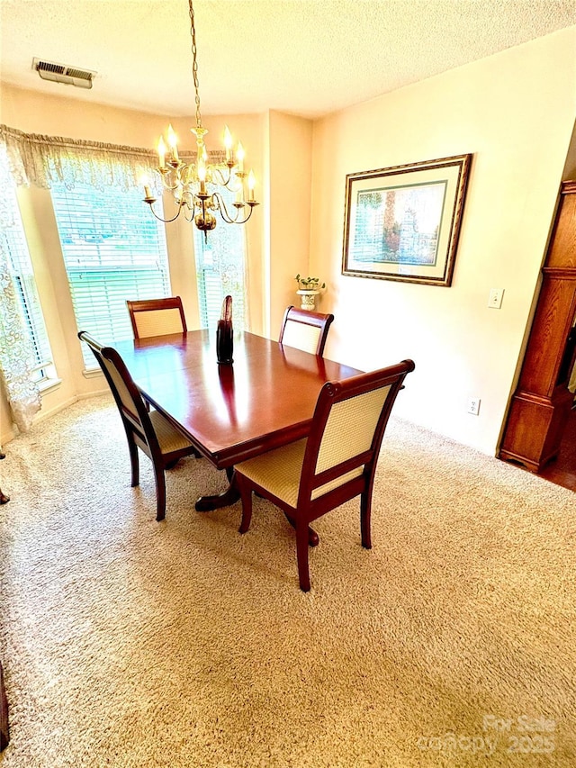 1902 Stonewyck Ave, Kannapolis, NC 28081 - dining area with a chandelier, carpet, and a textured ceiling