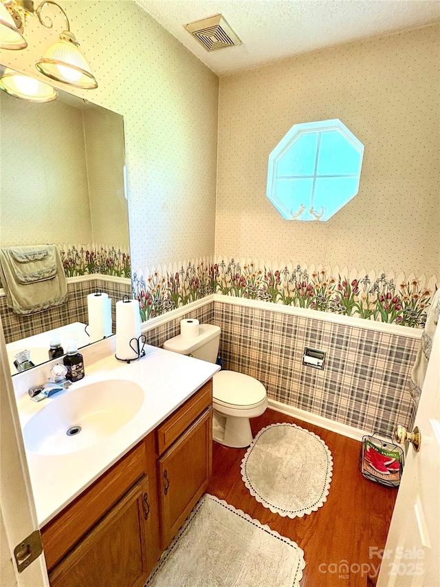 1902 Stonewyck Ave, Kannapolis, NC 28081 - half bathroom featuring wallpapered walls, wood finished floors, and vanity