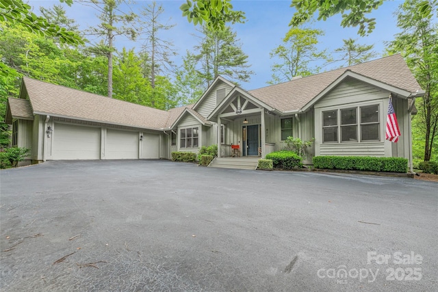 877 Winding Creek Rd, Sapphire, NC 28774 - ranch-style home with a garage, driveway, board and batten siding, and a shingled roof