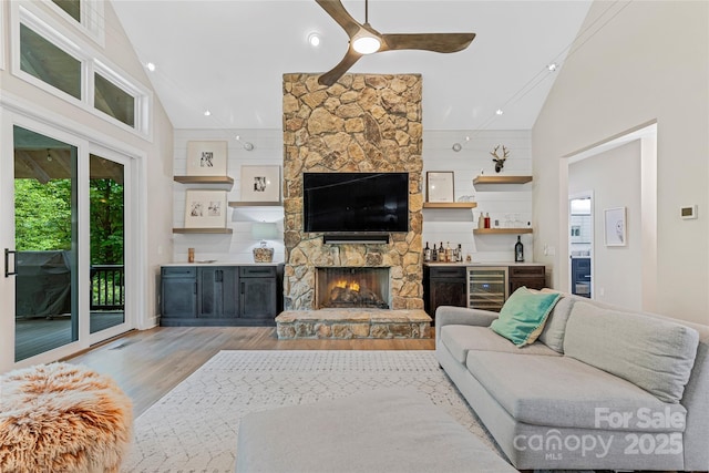 877 Winding Creek Rd, Sapphire, NC 28774 - living room with light wood-type flooring, a ceiling fan, a fireplace, plenty of natural light, and lofted ceiling