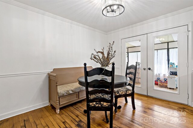 233 Church St, Ellenboro, NC 28040 - dining room featuring french doors, wood-type flooring, ornamental molding, and a chandelier