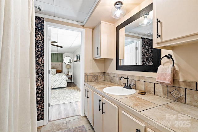 233 Church St, Ellenboro, NC 28040 - bathroom featuring vanity, ensuite bathroom, and decorative backsplash