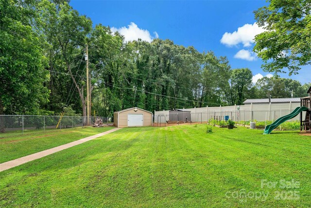 233 Church St, Ellenboro, NC 28040 - fenced backyard with a playground, a storage unit, and a detached garage