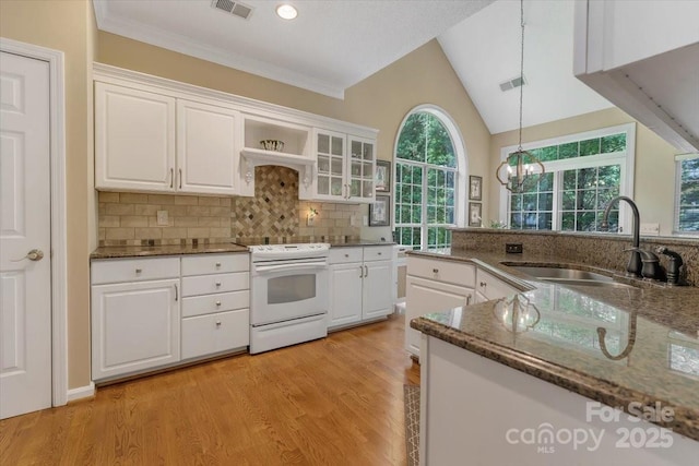 9040 Scottsboro Dr, Huntersville, NC 28078 - kitchen with white electric stove, white cabinetry, decorative backsplash, pendant lighting, and vaulted ceiling