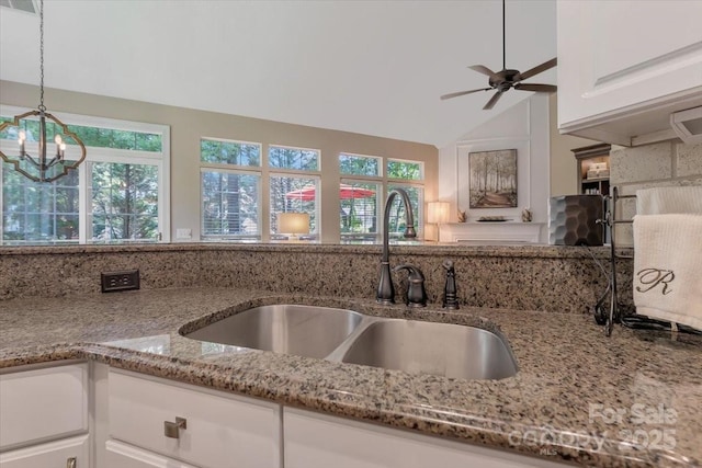 9040 Scottsboro Dr, Huntersville, NC 28078 - kitchen with plenty of natural light, light stone countertops, white cabinets, and lofted ceiling