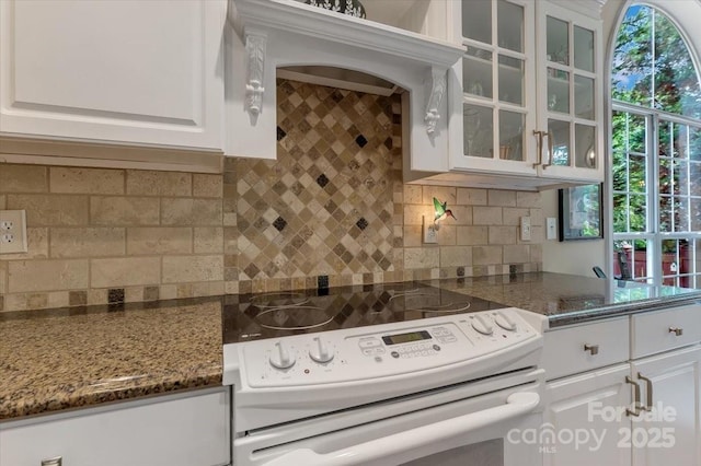 9040 Scottsboro Dr, Huntersville, NC 28078 - kitchen featuring white range with electric cooktop, white cabinetry, glass insert cabinets, and tasteful backsplash
