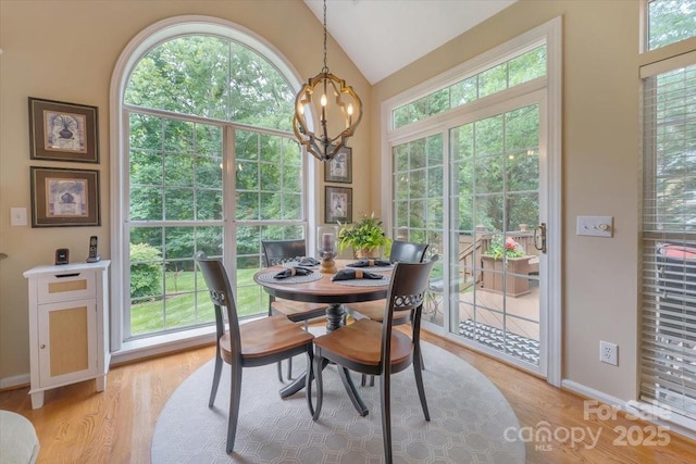 9040 Scottsboro Dr, Huntersville, NC 28078 - dining area with a chandelier, vaulted ceiling, and light wood-type flooring