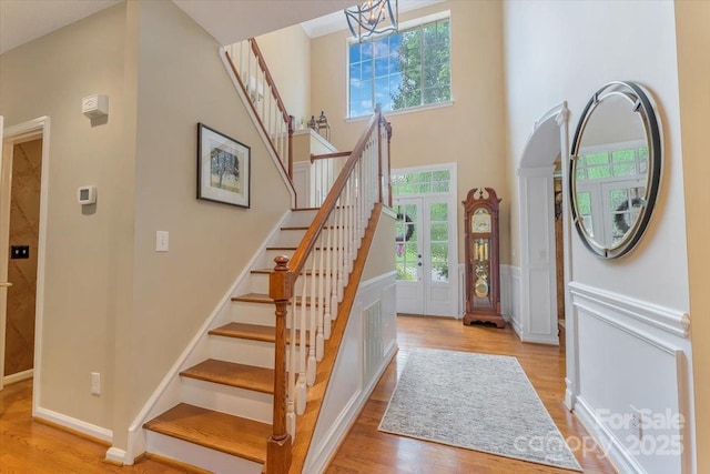 9040 Scottsboro Dr, Huntersville, NC 28078 - entrance foyer with healthy amount of natural light, light wood-style flooring, wainscoting, a high ceiling, and a decorative wall