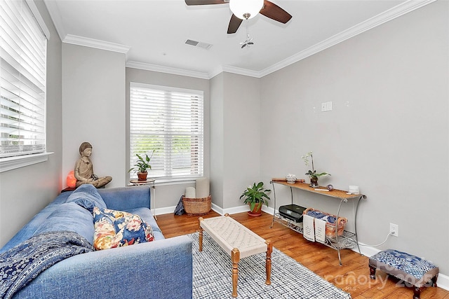 921 NE Dr, Davidson, NC 28036 - living area with wood finished floors, ceiling fan, and ornamental molding