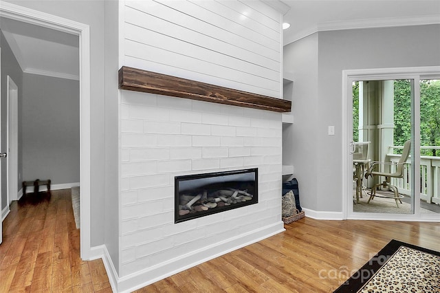 921 NE Dr, Davidson, NC 28036 - detailed view of ornamental molding, a glass covered fireplace, wood finished floors, and recessed lighting