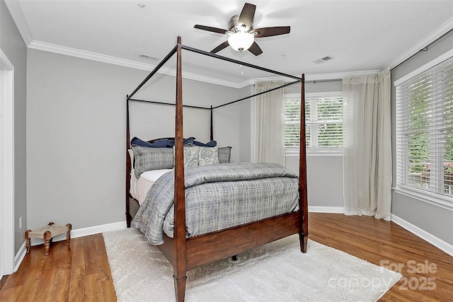 921 NE Dr, Davidson, NC 28036 - bedroom with crown molding, wood finished floors, and a ceiling fan