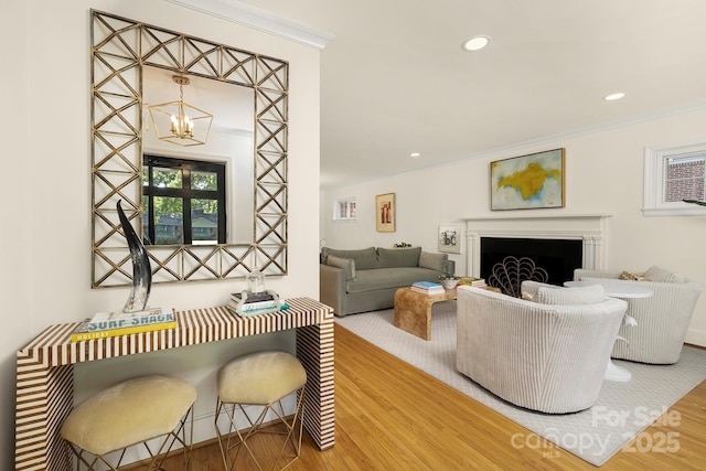 4526 Longwood Dr, Charlotte, NC 28209 - living room featuring wood finished floors, a chandelier, ornamental molding, a fireplace, and recessed lighting
