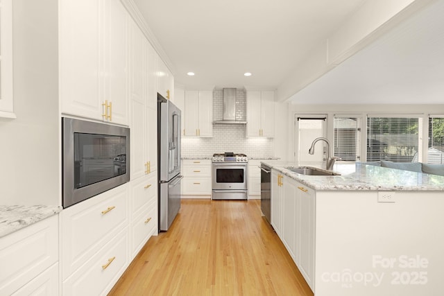 4526 Longwood Dr, Charlotte, NC 28209 - kitchen with appliances with stainless steel finishes, wall chimney exhaust hood, light wood-style floors, tasteful backsplash, and white cabinetry
