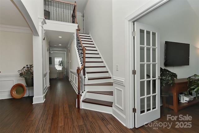 3913 Widgeon Way, Waxhaw, NC 28173 - staircase featuring crown molding, wood finished floors, wainscoting, and a decorative wall