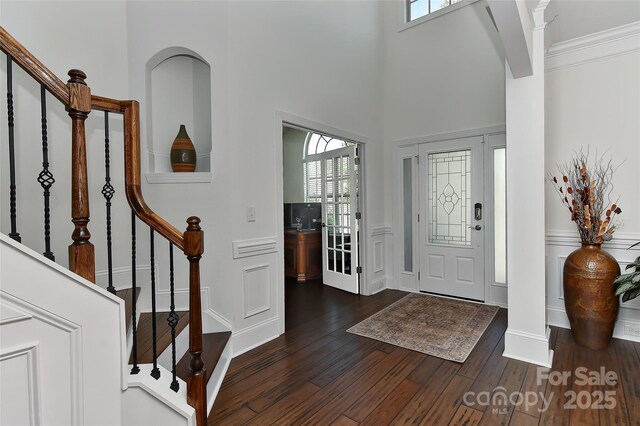 3913 Widgeon Way, Waxhaw, NC 28173 - entryway with dark wood-style floors, stairway, plenty of natural light, a decorative wall, and wainscoting