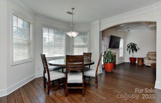 3913 Widgeon Way, Waxhaw, NC 28173 - dining room with arched walkways, dark wood finished floors, ornamental molding, and a fireplace