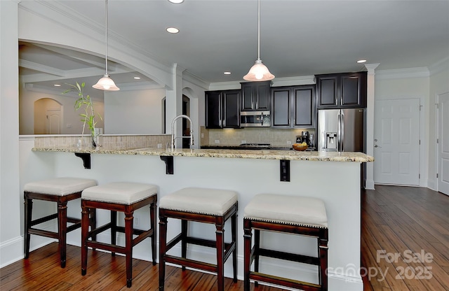 3913 Widgeon Way, Waxhaw, NC 28173 - kitchen featuring stainless steel appliances, arched walkways, tasteful backsplash, dark wood-style floors, and dark cabinets
