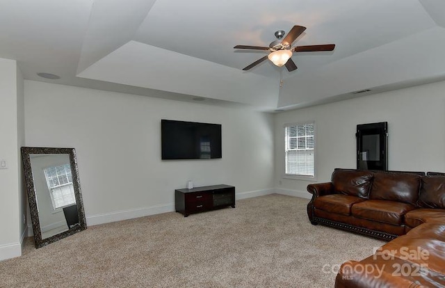 3913 Widgeon Way, Waxhaw, NC 28173 - living room with light colored carpet, a ceiling fan, plenty of natural light, and a tray ceiling
